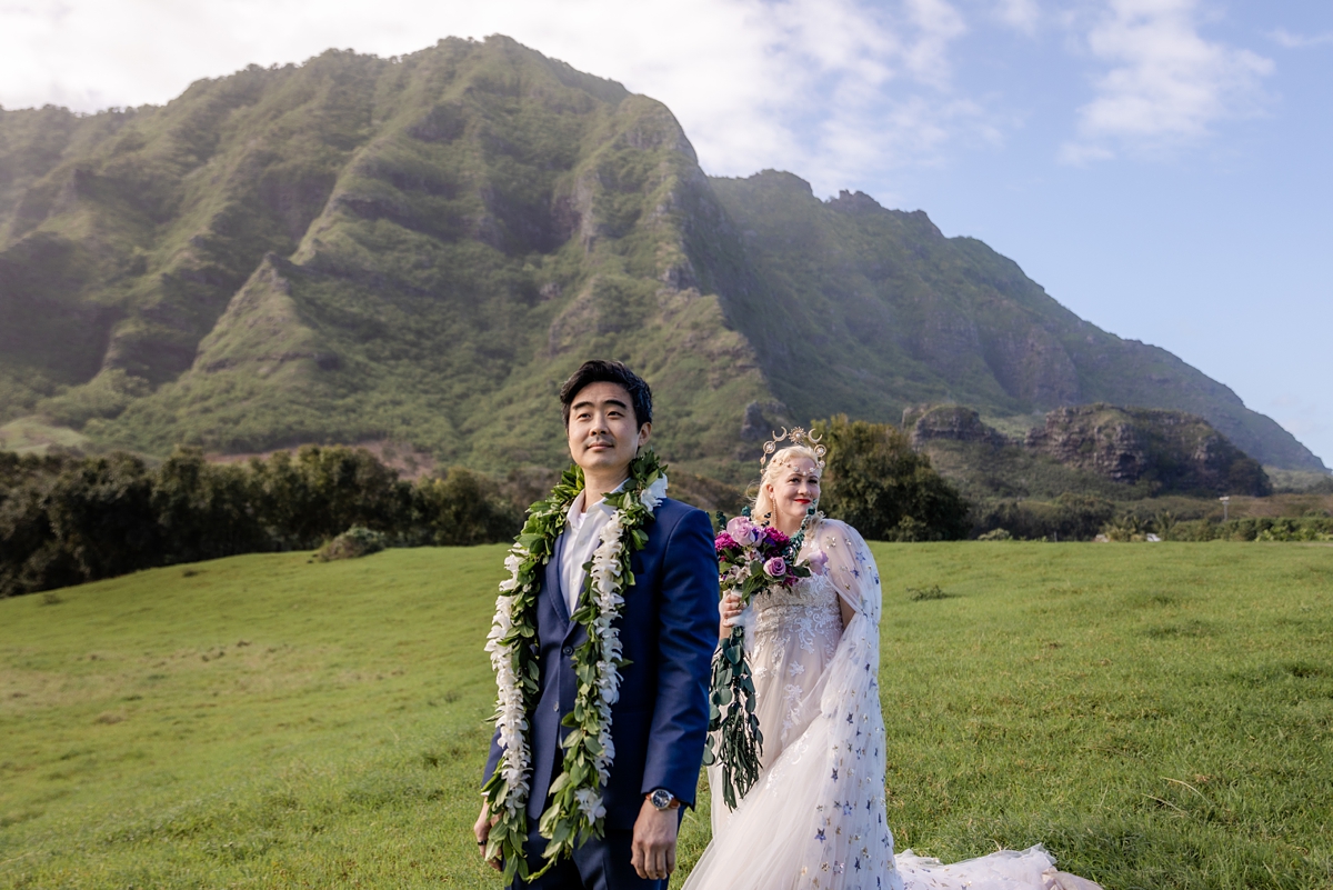 bride and groom doing a first look with a mountain backdrop