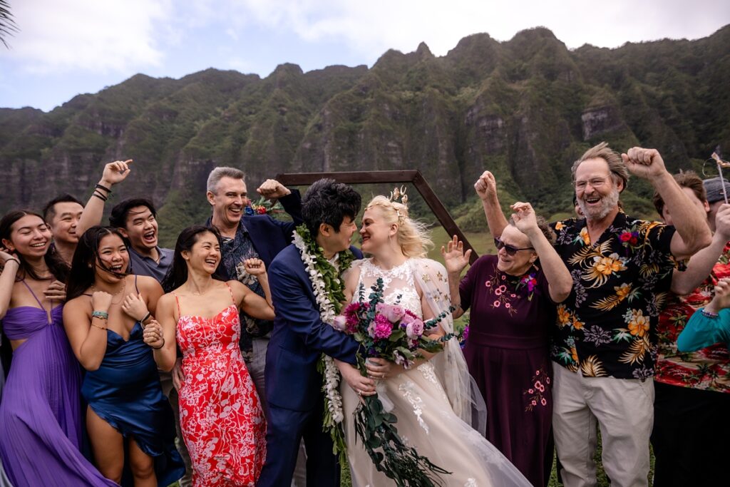 bride and groom celebrating with family and friends at Kualoa Ranch Wedding with Iwalani Photography