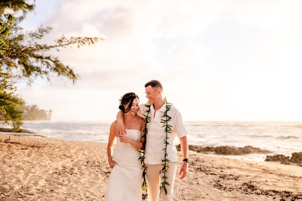 couple taking wedding portraits on a beach photography by oahu wedding photograper Iwalani Photography