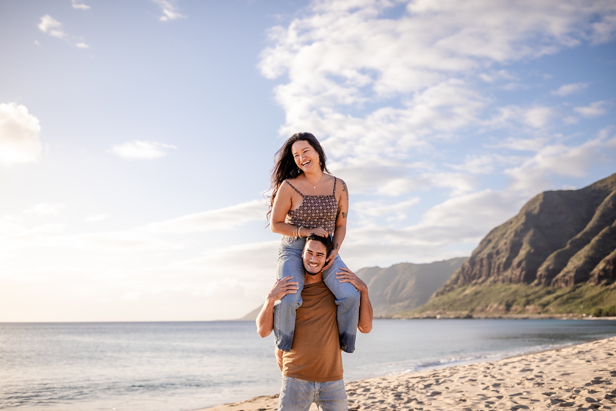 couple taking photos by the beach photography by oahu wedding photographer Iwalani Photography