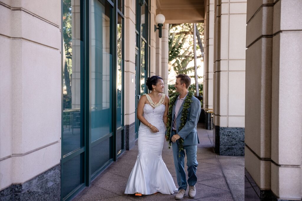 couple taking wedding portraits in downtown Honolulu photography by oahu wedding photograper Iwalani Photography