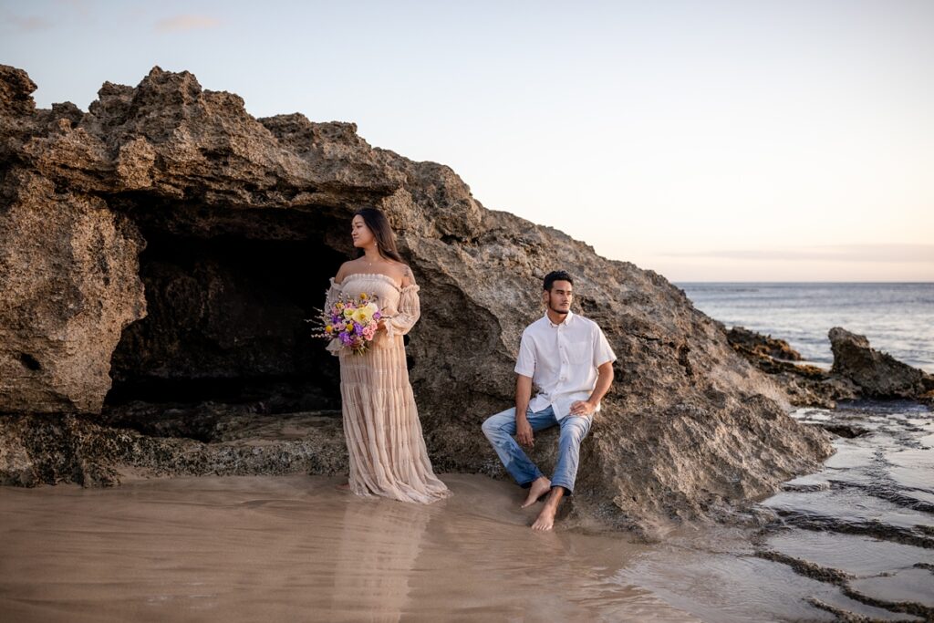 couple on beach taking photos