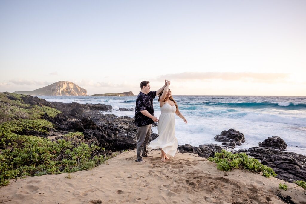 couple taking engagement photos on Oahu, Hawaii with Iwalani Photography